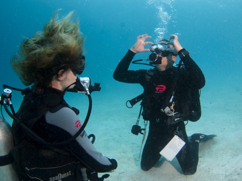 Instructor and student demonstrating proper 'Mask Clearing',  Mabul, Sabah, Malaysia